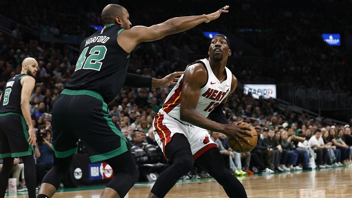 Miami Heat center Bam Adebayo (13) looks for a way around Boston Celtics center Al Horford (42) during the first quarter of game five of the first round of the 2024 NBA playoffs at TD Garden.