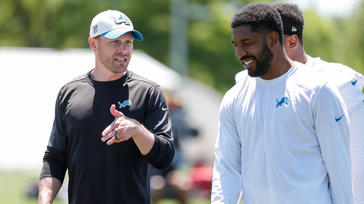 Detroit Lions offensive coordinator Ben Johnson talks to linebacker Jalen Reeves-Maybin (42) after practice during OTAs at Detroit Lions headquarters and training facility in Allen Park on Thursday, May 30, 2024.