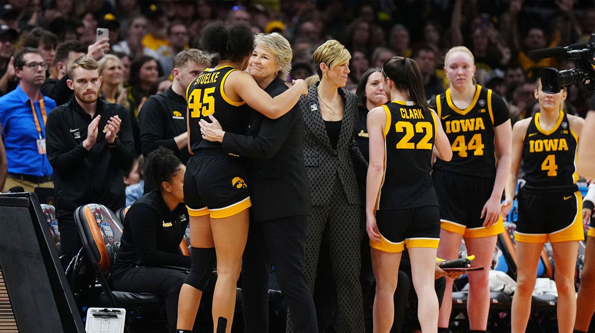Iowa Hawkeyes forward Hannah Stuelke (45) embraces head coach Lisa Bluder in the fourth quarter against the South Carolina Gamecocks in the finals of the Final Four of the womens 2024 NCAA Tournament.