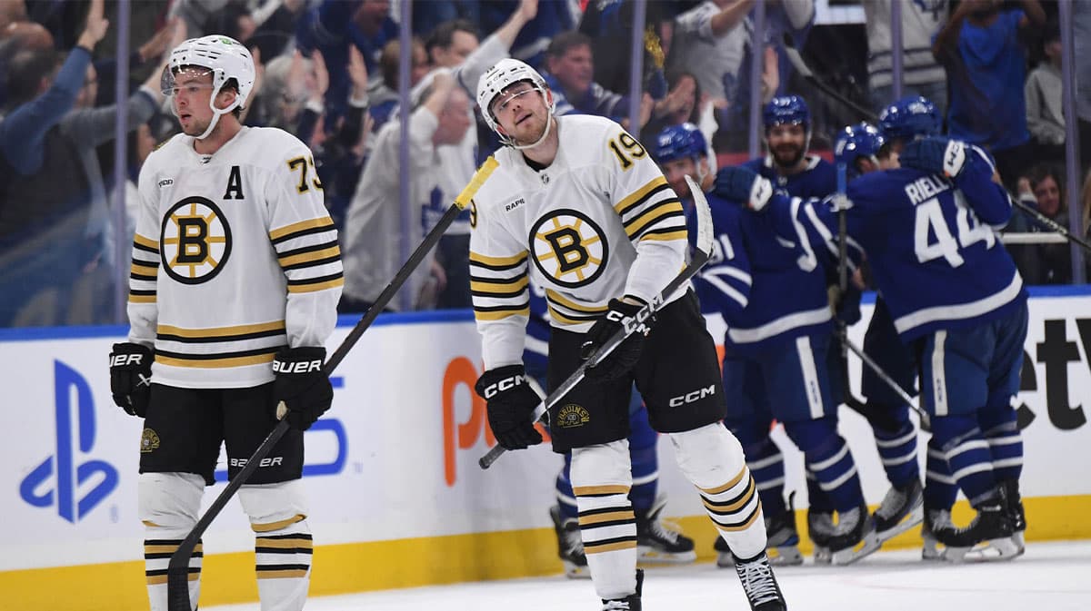  Boston Bruins defenseman Charlie McAvoy (73) and forward John Beecher (19) react as Toronto Maple Leafs players celebrate a goal by William Nylander (88) in the second period in game six of the first round of the 2024 Stanley Cup Playoffs at Scotiabank Arena.