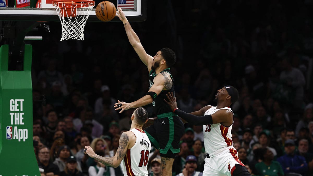 May 1, 2024; Boston, Massachusetts, USA; Boston Celtics forward Jayson Tatum (0) goes to the basket past Miami Heat center Bam Adebayo (13) during the third quarter of game five of the first round of the 2024 NBA playoffs at TD Garden. Mandatory Credit: Winslow Townson-USA TODAY Sports