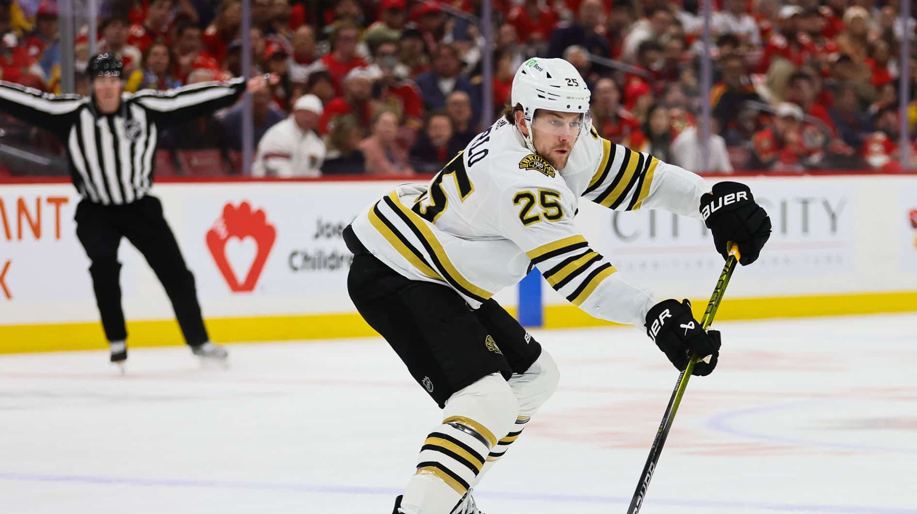 Boston Bruins defenseman Brandon Carlo (25) moves the puck against the Florida Panthers during the first period in game one of the second round of the 2024 Stanley Cup Playoffs at Amerant Bank Arena.