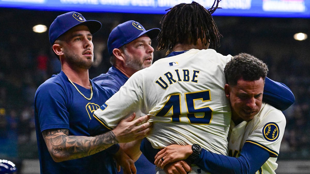 Milwaukee Brewers pitcher Abner Uribe (45) is restrained by teammates during a brawl with Tampa Bay Rays in the eighth inning at American Family Field.