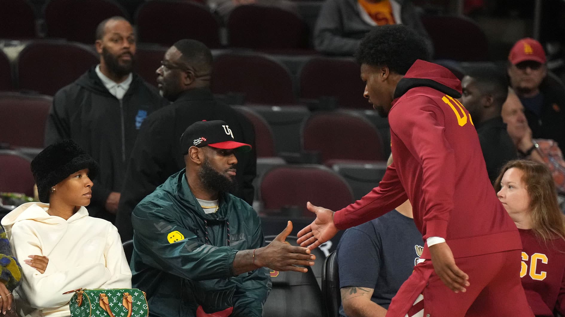 Southern California Trojans guard Bronny James (6) is greeted by father LeBron James during the game against the Washington State Cougars at Galen Center. 
