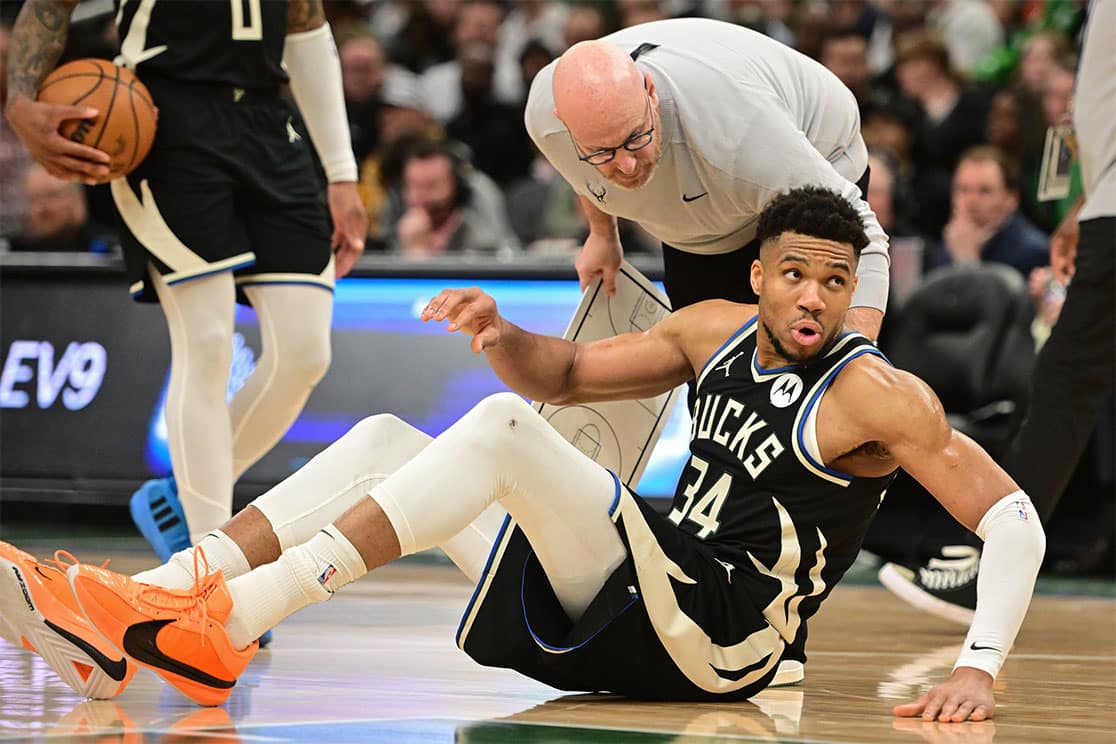 Apr 9, 2024; Milwaukee, Wisconsin, USA; Milwaukee Bucks forward Giannis Antetokounmpo (34) is helped off the floor in the third quarter and left game against the Boston Celtics with an injury at Fiserv Forum.