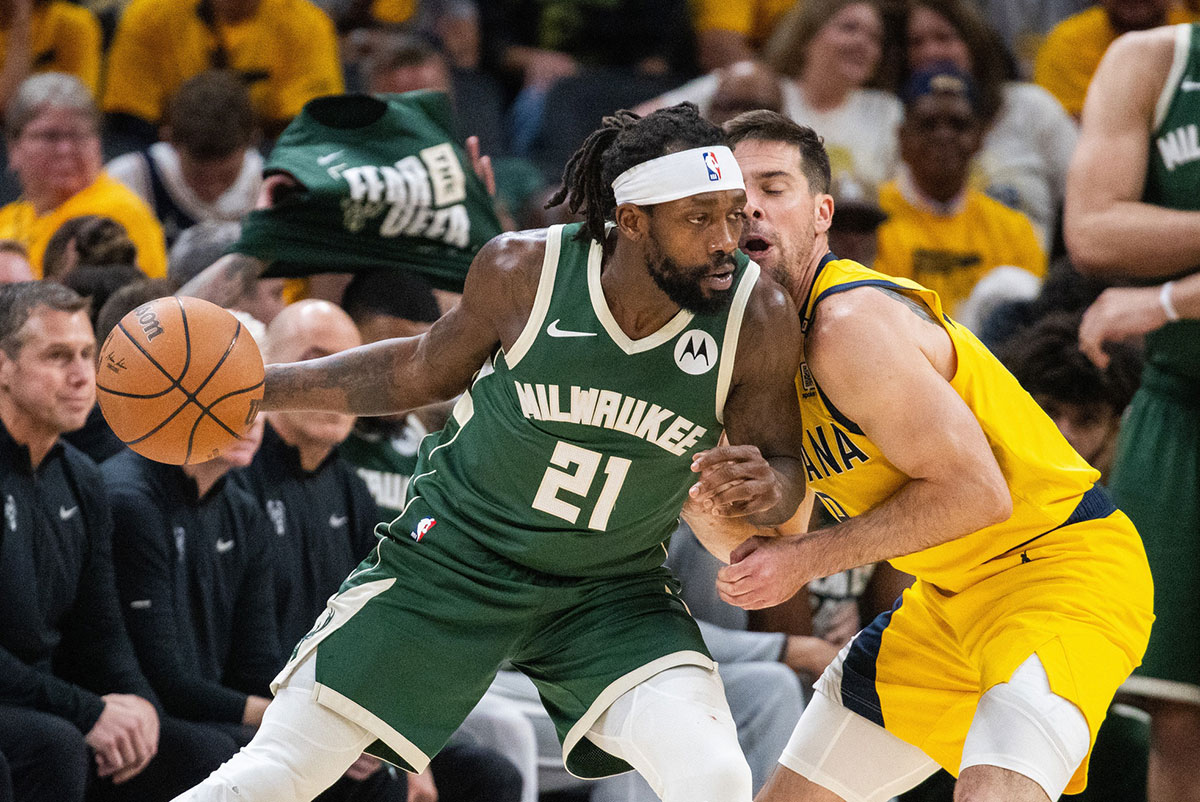 Milwaukee Bucks guard Patrick Beverley (21) dribbles the ball while Indiana Pacers guard T.J. McConnell (9) defends during game six of the first round for the 2024 NBA playoffs at Gainbridge Fieldhouse.