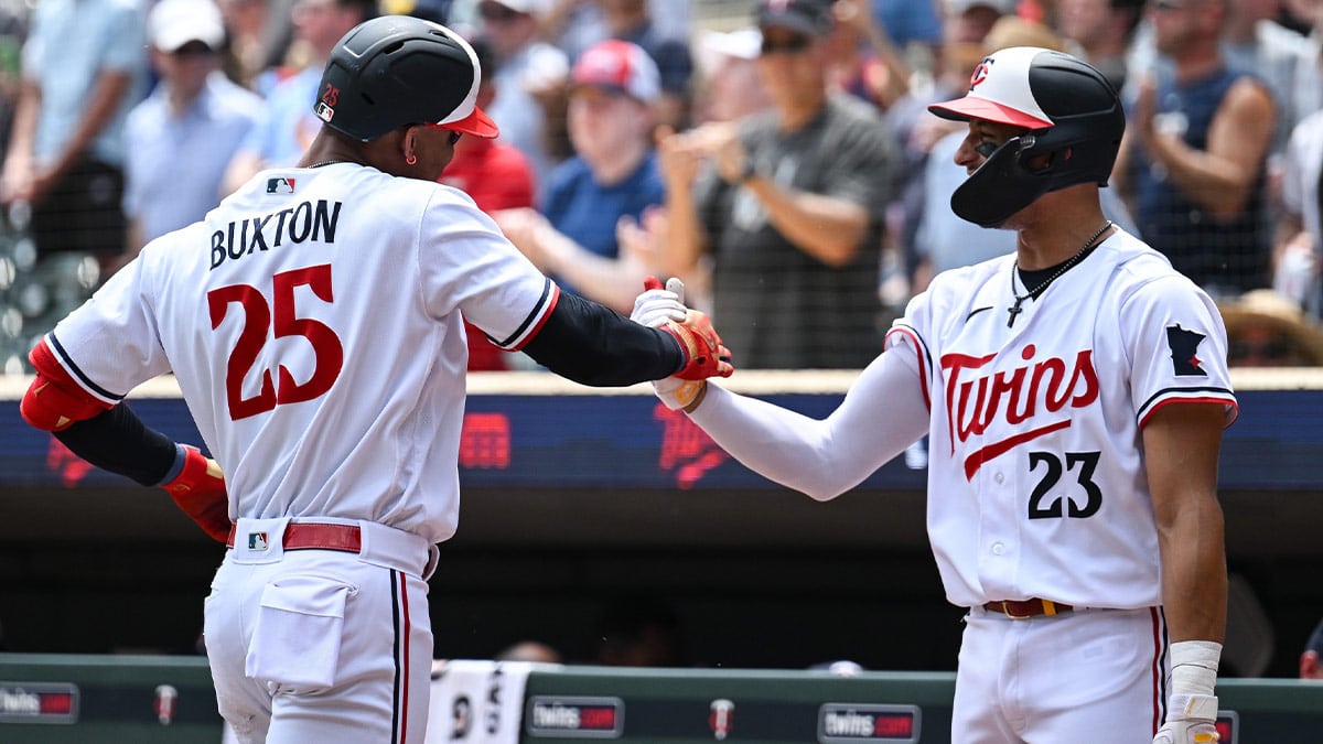 Minnesota Twins designated hitter Byron Buxton (25) and third baseman Royce Lewis (23) react after Buxton hit his second home run of the day during the third inning at Target Field.