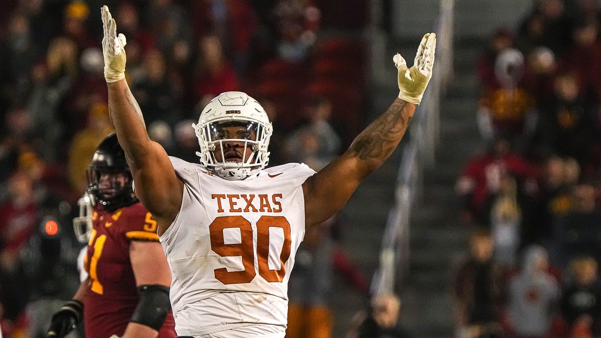 Texas Longhorns defensive lineman Byron Murphy II (90) celebrates sacking Iowa State quarterback Rocco Becht (3) during the game at Jack Trice Stadium on Saturday, Nov. 8, 2023 in Ames, Iowa.