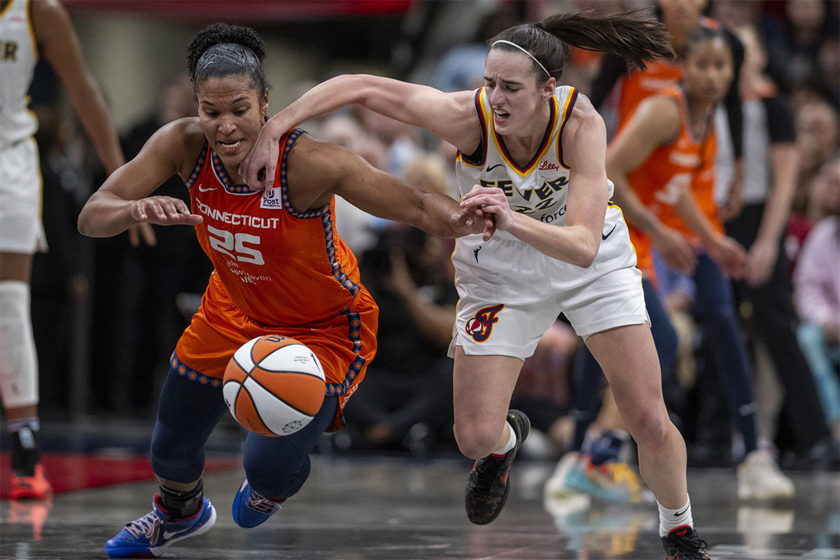 Connecticut Sun forward Alyssa Thomas (25) knocks the ball away from Indiana Fever guard Caitlin Clark (22) during the second half of an WNBA basketball game,