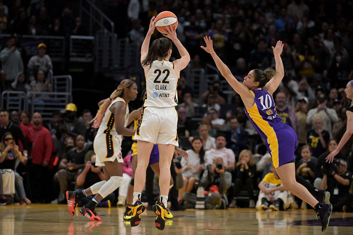 Indiana Fever guard Caitlin Clark (22) shoots a 3-point basket over Los Angeles Sparks guard Kia Nurse (10) in the final seconds at Crypto.com Arena. 