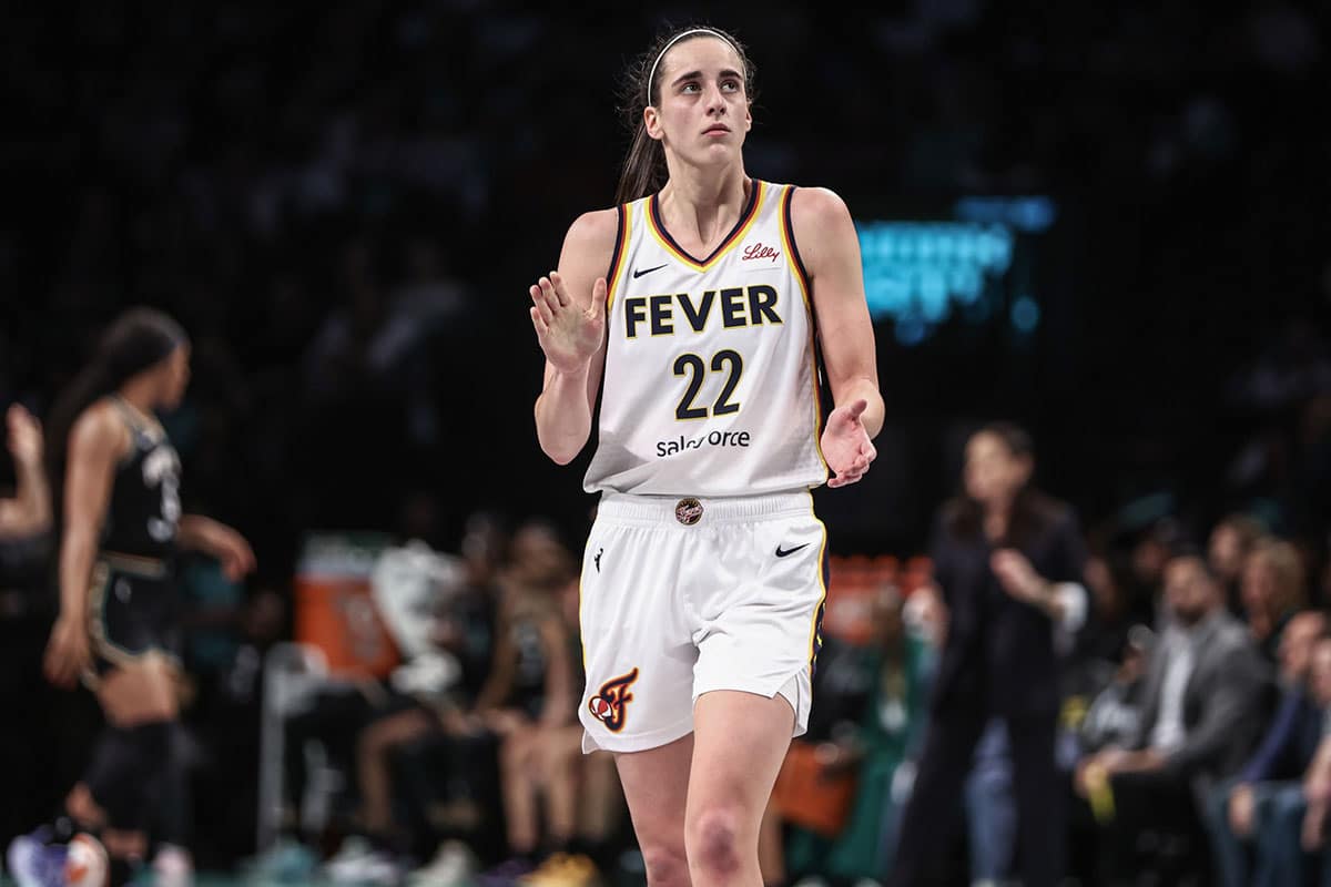 Indiana Fever guard Caitlin Clark (22) applauds while looking at the scoreboard in the third quarter against the New York Liberty at Barclays Center.