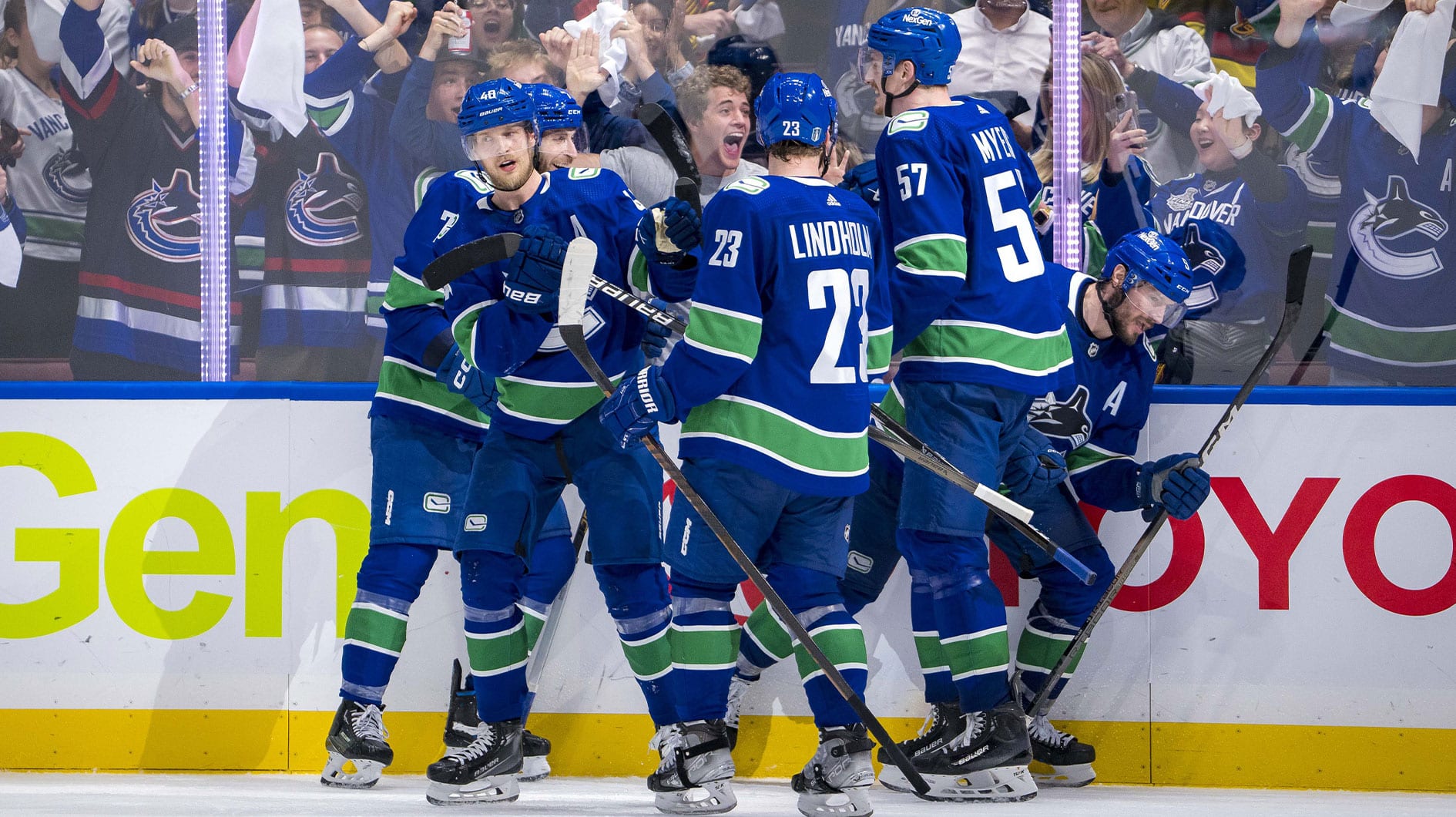 Vancouver Canucks forward Elias Pettersson (40) and defenseman Tyler Myers (57) and forward J.T. Miller (9) and defenseman Carson Soucy (7) celebrate after the game winning goal against the Edmonton Oilers during the third period in game five of the second round of the 2024 Stanley Cup Playoffs at Rogers Arena.