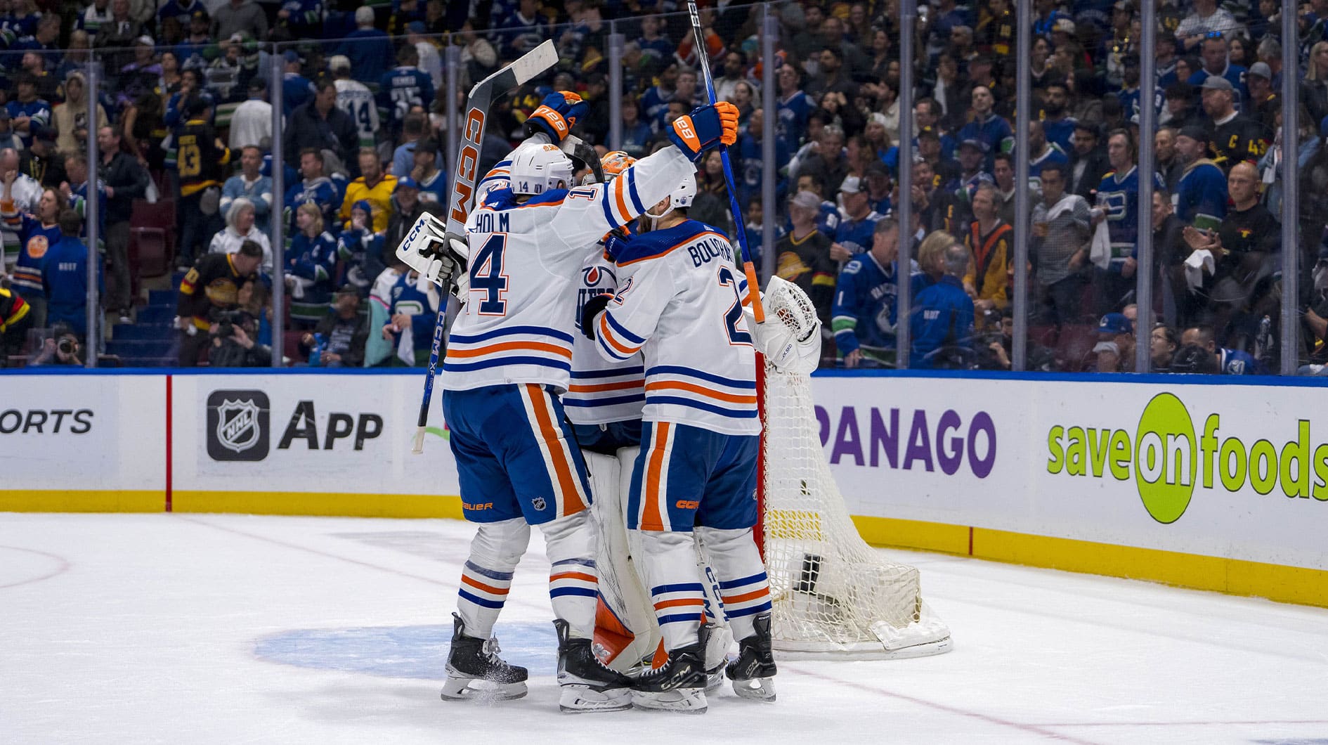 Edmonton Oilers defenseman Mattias Ekholm (14) and defenseman Evan Bouchard (2) and goalie Stuart Skinner (74) celebrate their victory over the Vancouver Canucks in game seven of the second round of the 2024 Stanley Cup Playoffs at Rogers Arena.