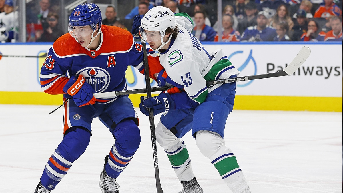 Edmonton Oilers forward Ryan Nugent-Hopkins (93) and Vancouver Canucks defensemen Quinn Hughes (43) battles for position during the third period at Rogers Place.