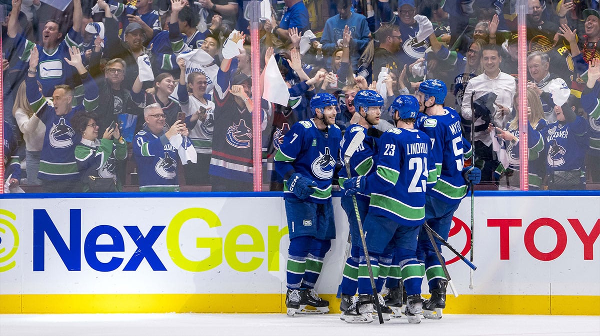 Vancouver Canucks forward Elias Pettersson (40) and defenseman Tyler Myers (57) and forward J.T. Miller (9) and defenseman Carson Soucy (7) celebrate after the game winning goal against the Edmonton Oilers during the third period in game five of the second round of the 2024 Stanley Cup Playoffs at Rogers Arena.