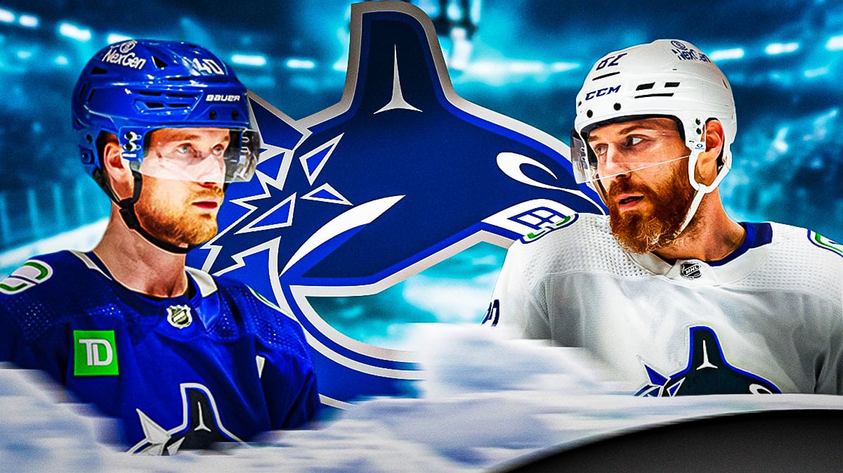 Elias Pettersson in middle of image looking stern, Ian Cole in image looking stern, Vancouver Canucks logo, hockey rink in background
