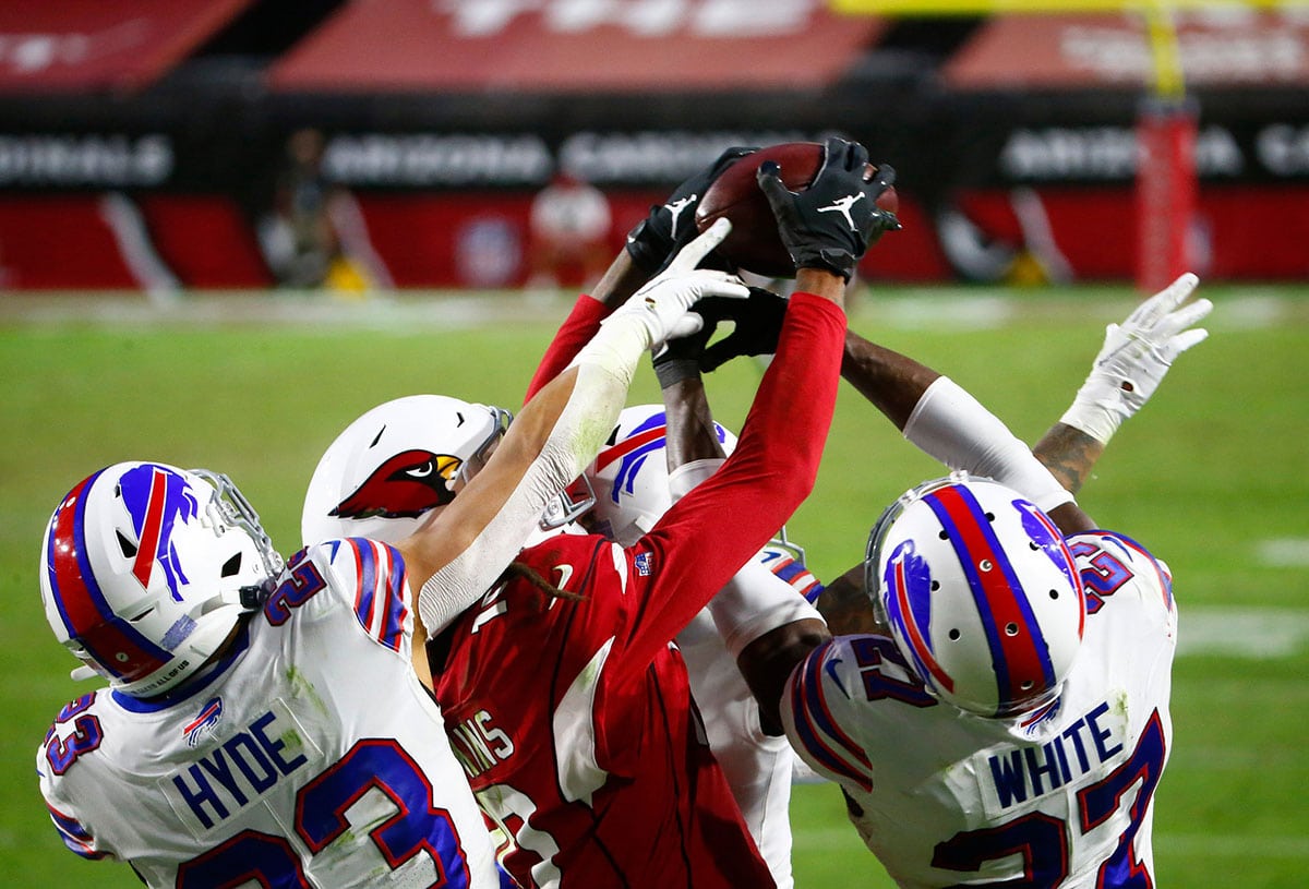 Cardinals' DeAndre Hopkins (10) catches a game-winning touchdown catch over Bill's Tre'Davious White (27) and Micah Hyde (23) with 2 seconds lett in the fourth quarter at State Farm Stadium in Glendale, Ariz. on Nov. 15, 2020. 