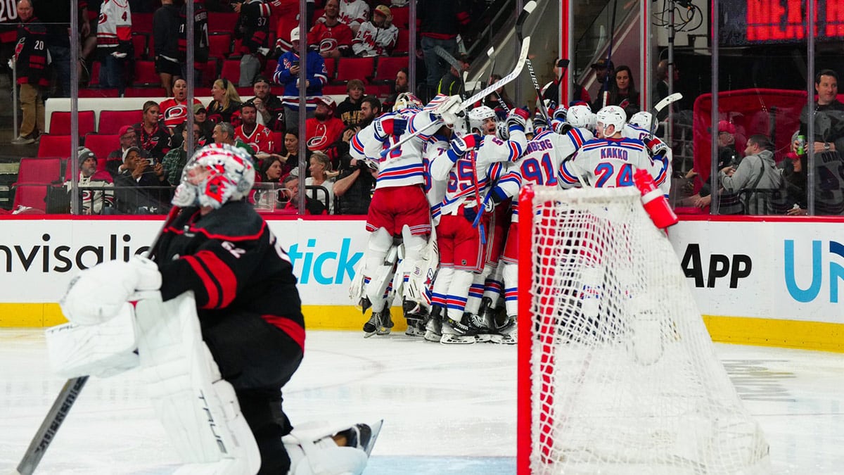 New York Rangers players celebrate their win in the overtime against the Carolina Hurricanes in game three of the second round of the 2024 Stanley Cup Playoffs at PNC Arena.