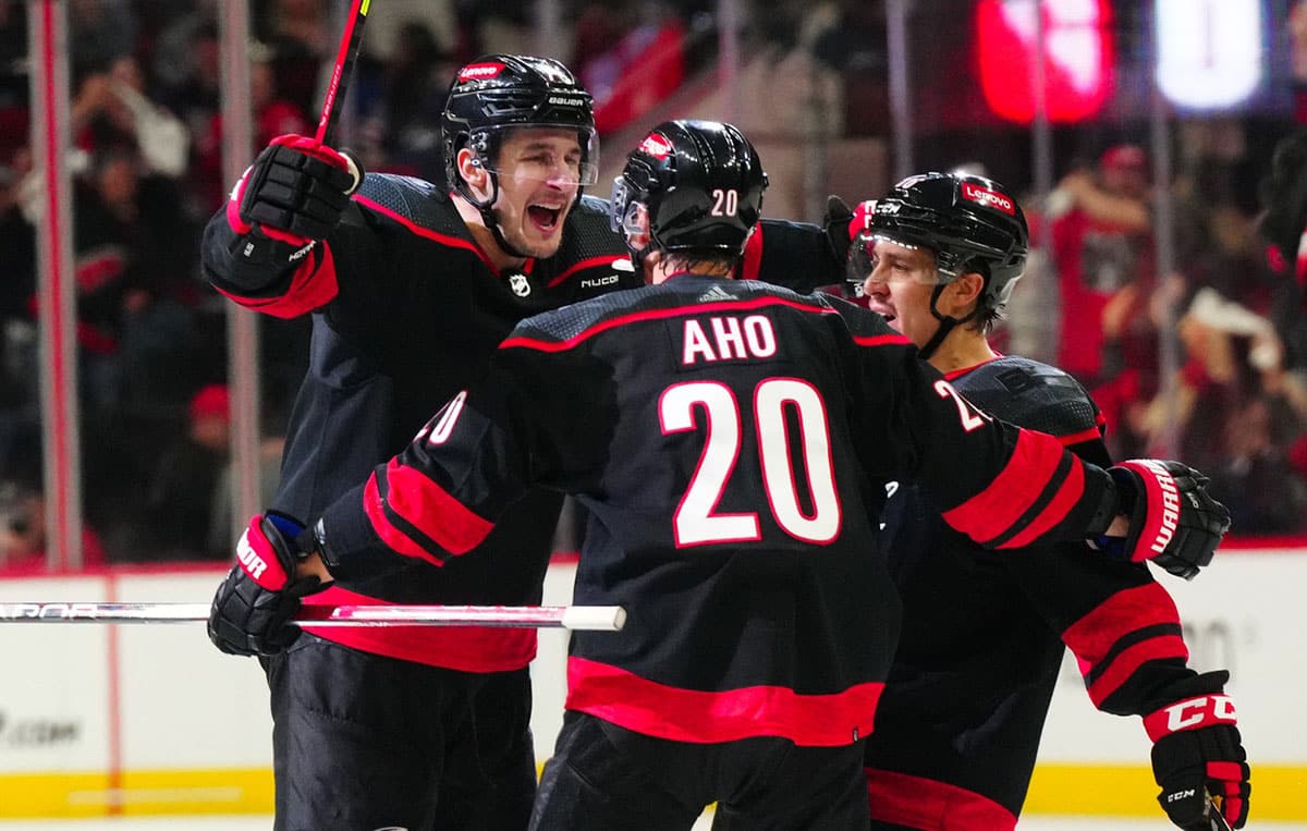 Carolina Hurricanes defenseman Brady Skjei (76) celebrates with center Sebastian Aho (20) and left wing Teuvo Teravainen (86) after scoring a goal against the New York Rangers during the third period in game four of the second round of the 2024 Stanley Cup Playoffs at PNC Arena.