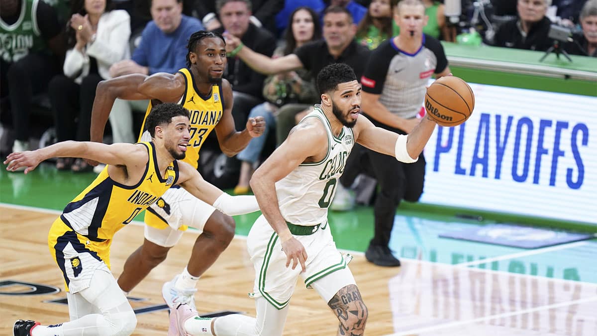 Boston Celtics forward Jayson Tatum (0) returns the ball against Indiana Pacers guard Tyrese Haliburton (0) in over-time during game one of the eastern conference finals for the 2024 NBA playoffs at TD Garden. 