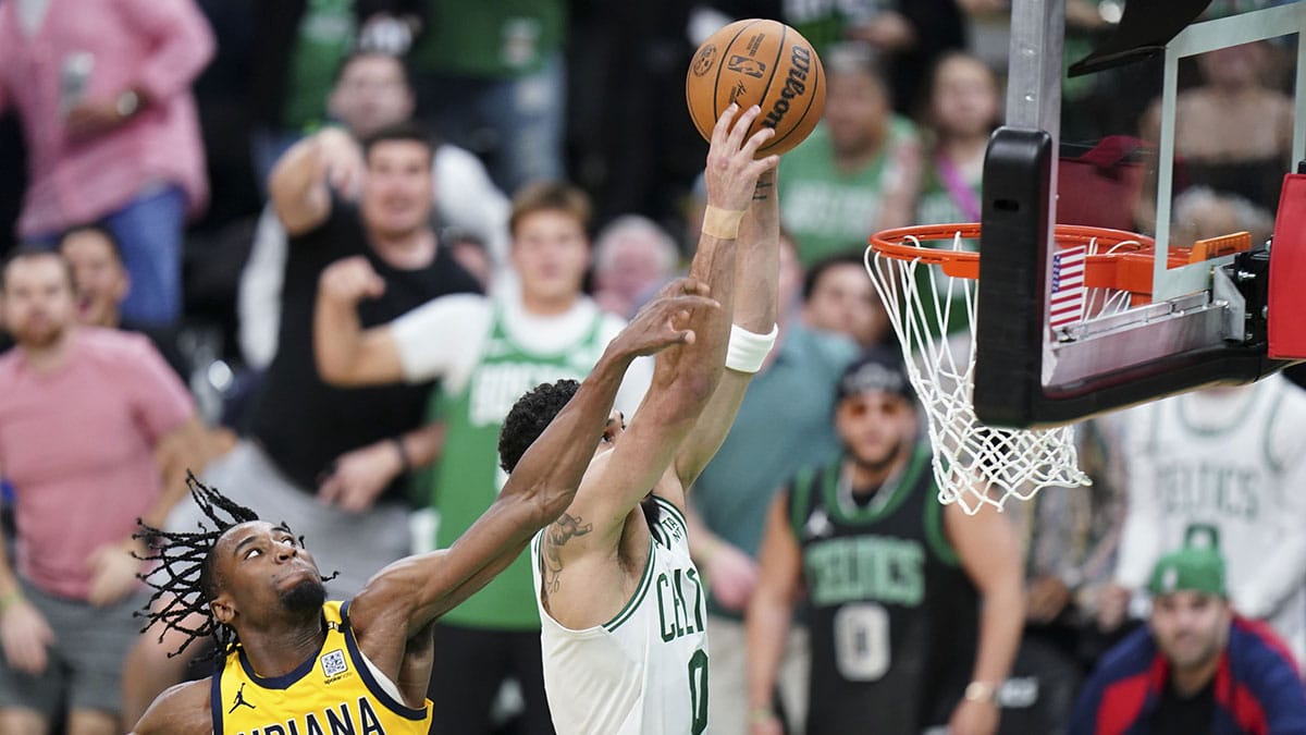 Indiana Pacers forward Aaron Nesmith (23) makes his fifth foul against Boston Celtics forward Jayson Tatum (0) in over-time during game one of the eastern conference finals for the 2024 NBA playoffs at TD Garden.