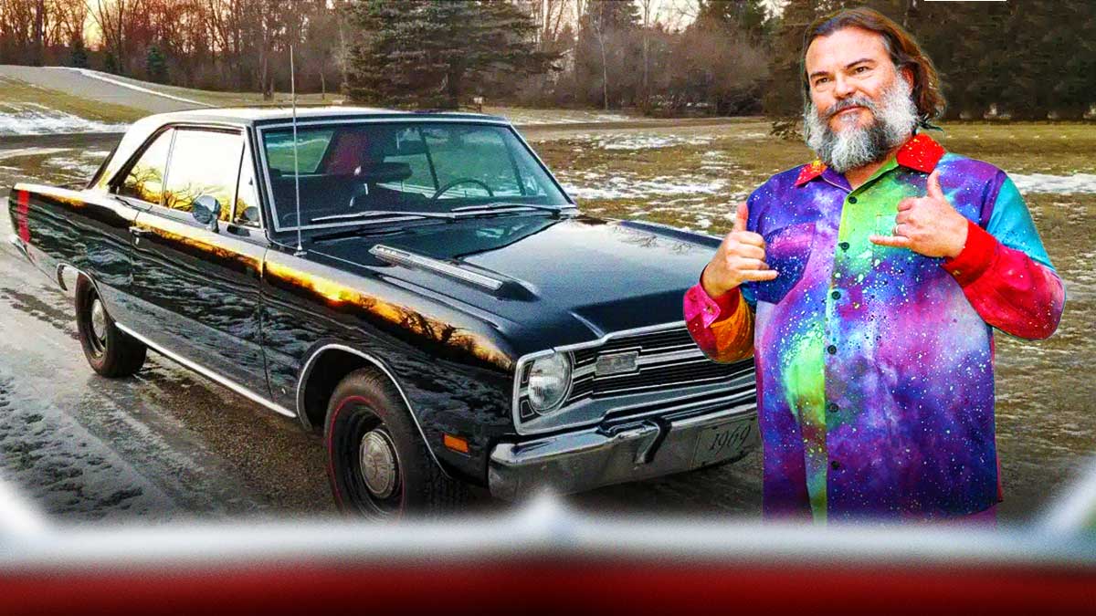 Jack Black in front of a car in his collection.