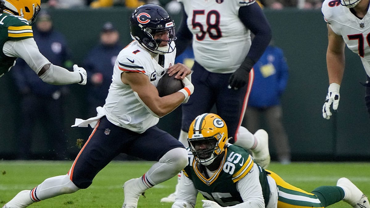 Chicago Bears quarterback Justin Fields (1) runs for q first down during the first quarter of their game against the Green Bay Packers Sunday, January 7, 2024 at Lambeau Field in Green Bay, Wisconsin.Mark Hoffman/Milwaukee Journal Sentinel