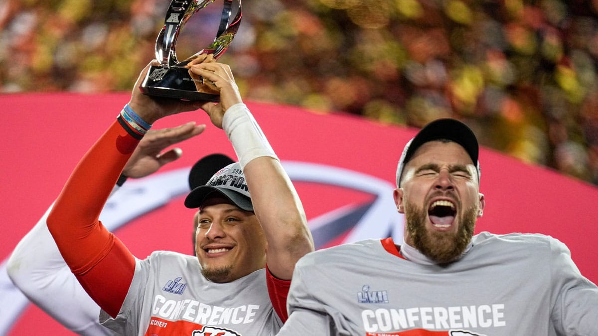 Patrick Mahomes raises the Lamar Hunt Trophy while Travis Kelce celebrates after the Kansas City Chiefs' 23-20 win over the Cincinnati Bengals in the AFC championship game at Arrowhead Stadium.