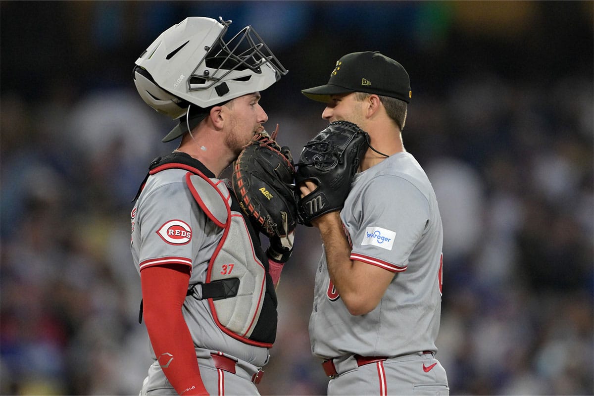 Cincinnati Reds right fielder Jake Fraley (27) talks with relief pitcher Carson Spiers (68) on the mound during the seventh inning against the Los Angeles Dodgers at Dodger Stadium. 