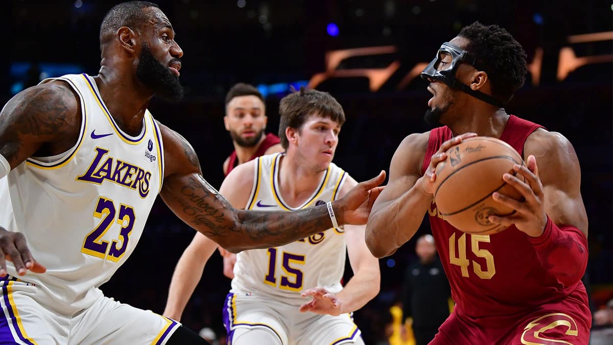Cleveland Cavaliers guard Donovan Mitchell (45) controls the ball against Los Angeles Lakers forward LeBron James (23) during the first half at Crypto.com Arena. 