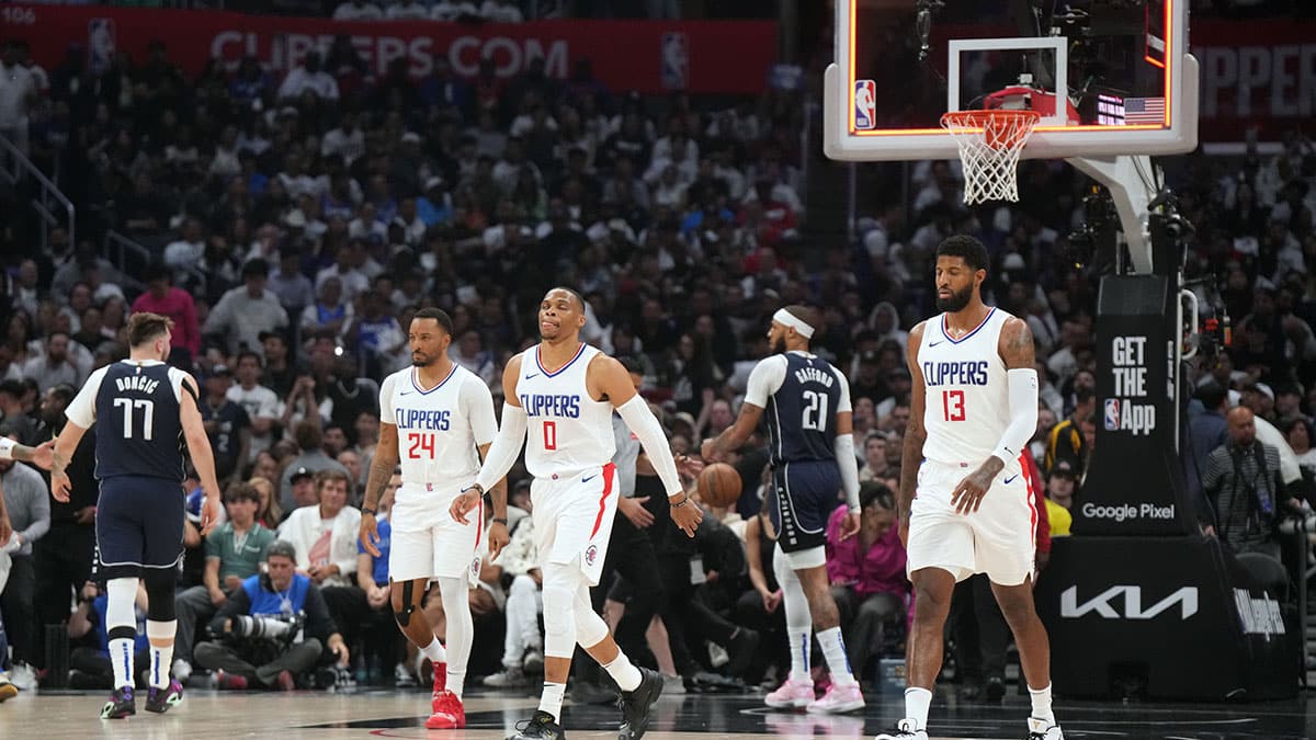 Clippers guard Norman Powell (24), guard Russell Westbrook (0) and forward Paul George (13) react at the end of the first half