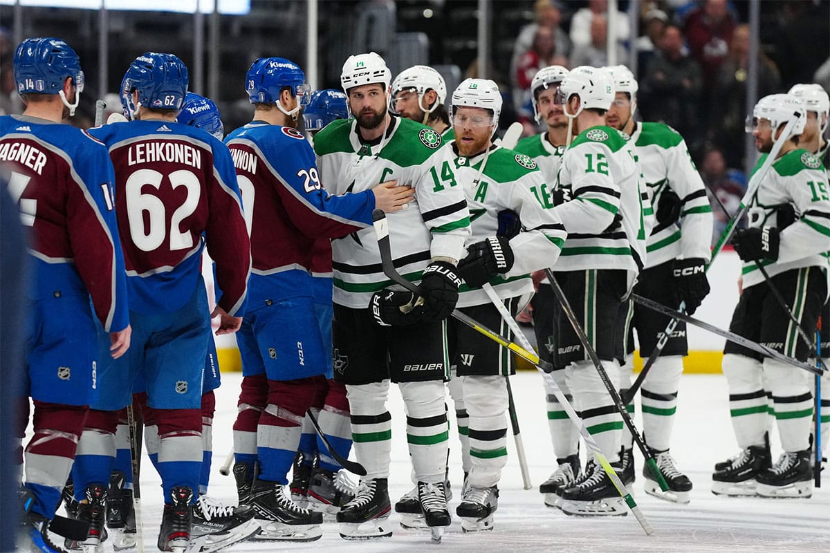 Dallas Stars left wing Jamie Benn (14) and Colorado Avalanche center Nathan MacKinnon (29) greet each other following a double overtime period in game six of the second round of the 2024 Stanley Cup Playoffs at Ball Arena
