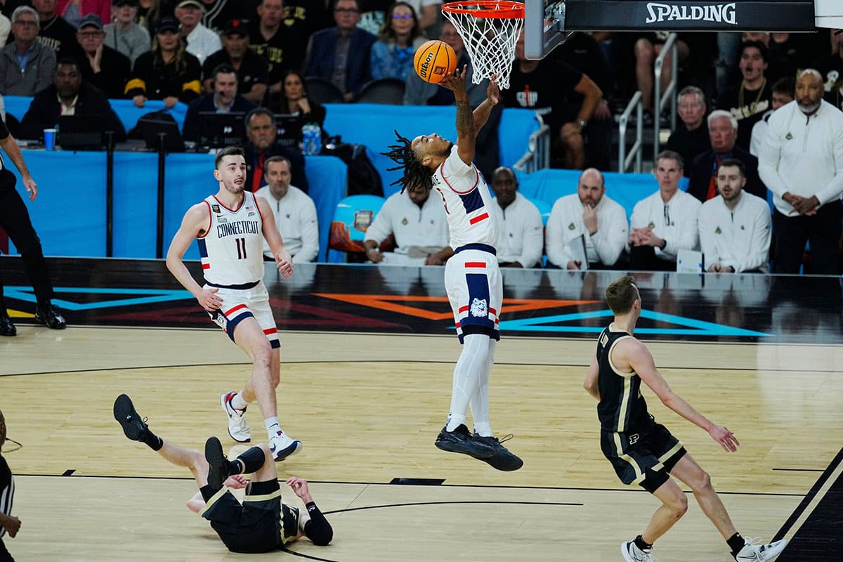 Connecticut Huskies guard Stephon Castle (5) shoots against Purdue Boilermakers guard Fletcher Loyer (2) and guard Braden Smith (3) in the first half in the national championship game of the 2024 NCAA Tournament at State Farm Stadium in Glendale on April 8, 2024.