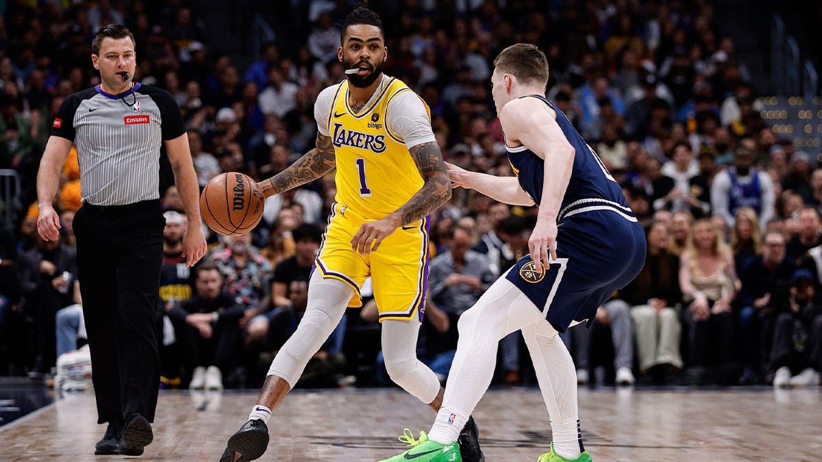 Los Angeles Lakers guard D'Angelo Russell (1) controls the ball as Denver Nuggets guard Christian Braun (0) guards in the first quarter during game five of the first round for the 2024 NBA playoffs at Ball Arena.