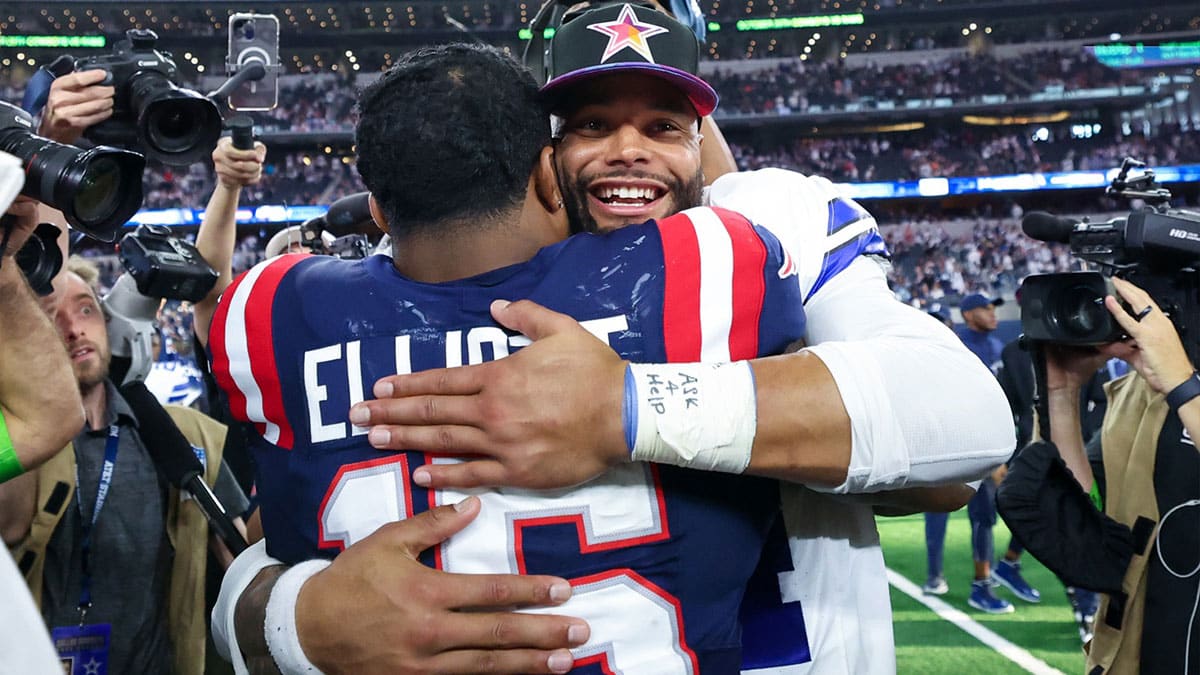 Dallas Cowboys quarterback Dak Prescott (4) hugs New England Patriots running back Ezekiel Elliott (15) after the game at AT&T Stadium.