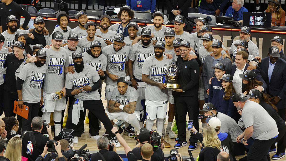 Dallas Mavericks players and staff celebrate after winning the Western Conference Championship against the Minnesota Timberwolves in game five of the western conference finals for the 2024 NBA playoffs at Target Center.