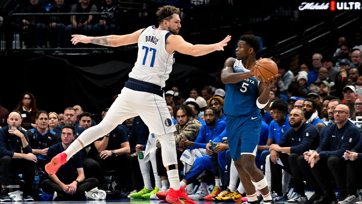 Jan 7, 2024; Dallas, Texas, USA; Dallas Mavericks guard Luka Doncic (77) attempts to knock the ball away from Minnesota Timberwolves guard Anthony Edwards (5) during the second half at the American Airlines Center. Mandatory Credit: Jerome Miron-USA TODAY Sports