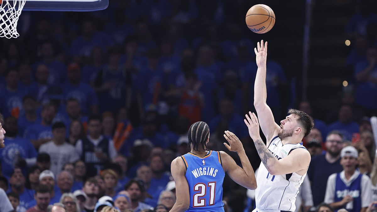 May 9, 2024; Oklahoma City, Oklahoma, USA; Dallas Mavericks guard Luka Doncic (77) shoots beside Oklahoma City Thunder guard Aaron Wiggins (21) during the second quarter of game two of the second round for the 2024 NBA playoffs at Paycom Center. Mandatory Credit: Alonzo Adams-USA TODAY Sports