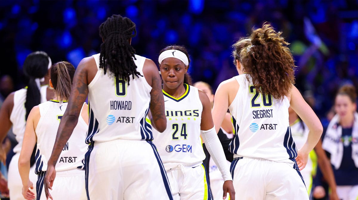 Dallas Wings guard Arike Ogunbowale (24) celebrates with Dallas Wings forward Natasha Howard (6) and Dallas Wings forward Maddy Siegrist (20) during the second half against the Chicago Sky at College Park Center.