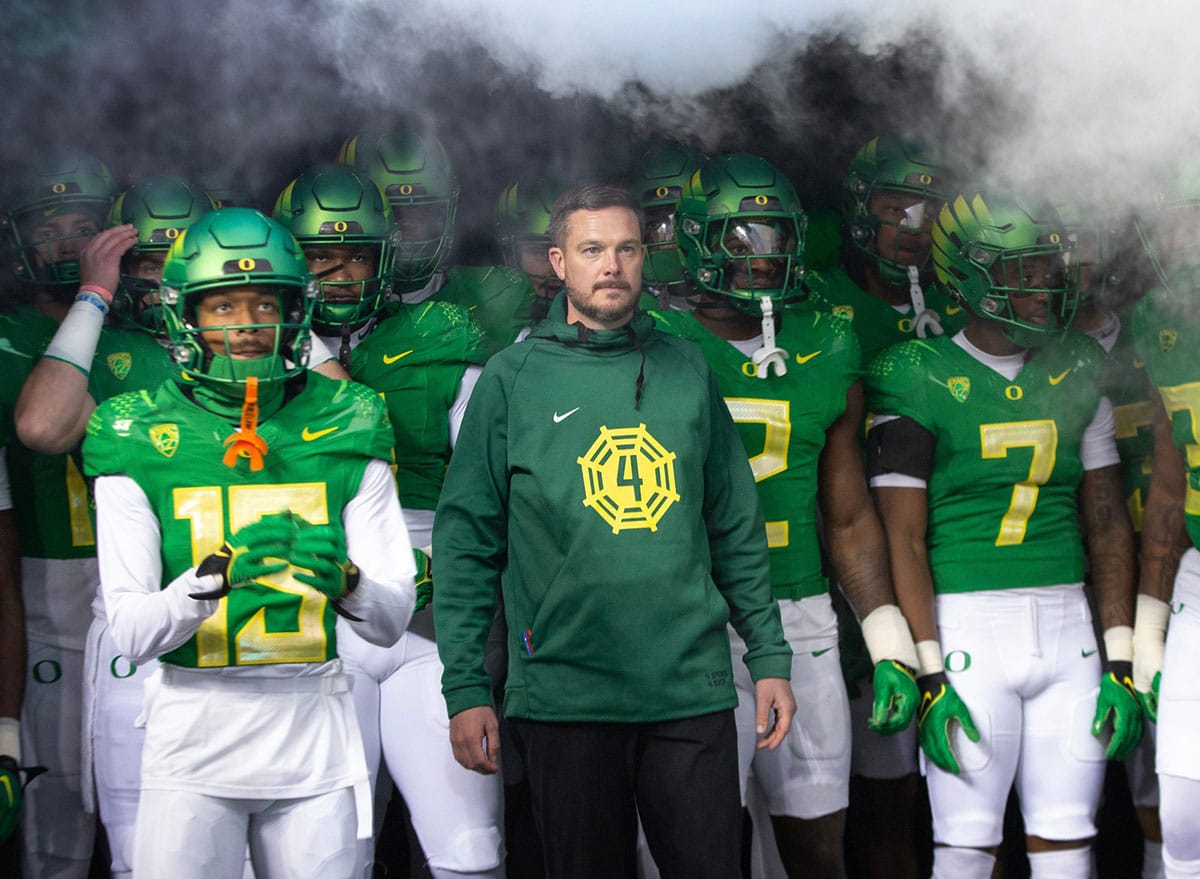 Oregon head coach Dan Lanning, center, waits to take the field with his team for their game against Oregon State 