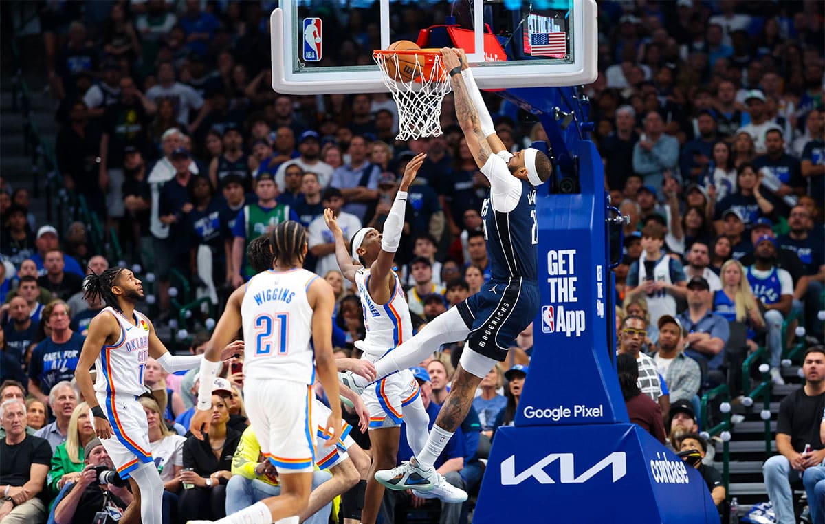 Dallas Mavericks center Daniel Gafford (21) dunks over Oklahoma City Thunder guard Shai Gilgeous-Alexander (2) during the second half during game three of the second round for the 2024 NBA playoffs at American Airlines Center.