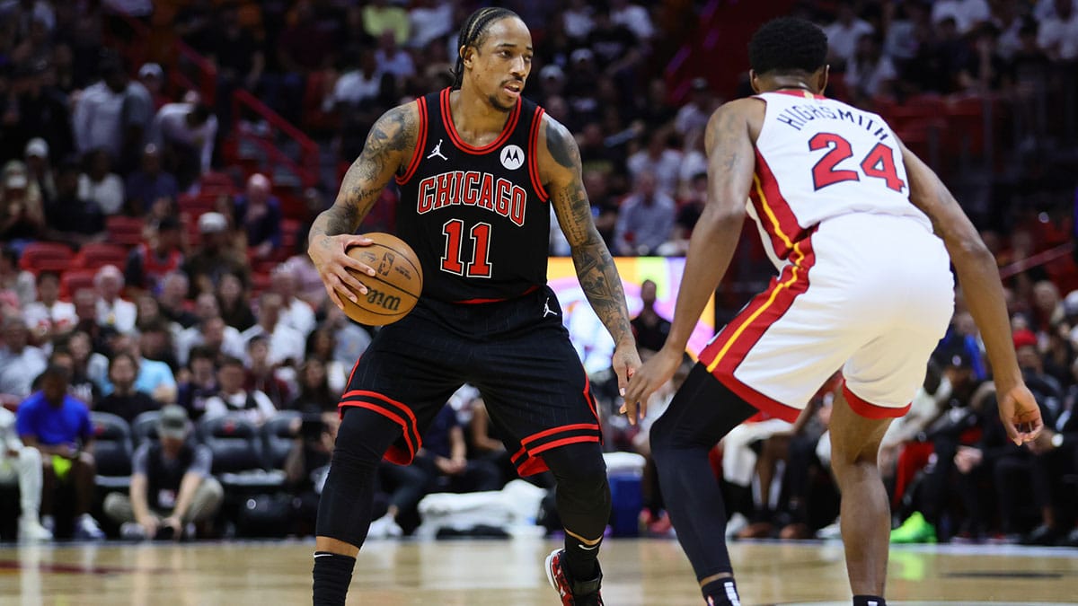 Chicago Bulls forward DeMar DeRozan (11) dribbles the basketball as Miami Heat forward Haywood Highsmith (24) defends in the first quarter during a play-in game of the 2024 NBA playoffs at Kaseya Center.