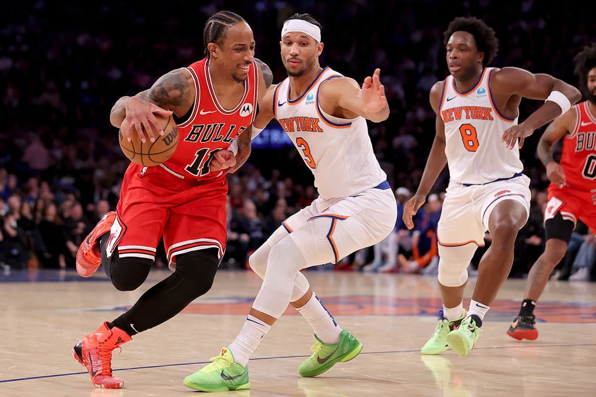 Chicago Bulls forward DeMar DeRozan (11) drives to the basket against New York Knicks guard Josh Hart (3) and forward OG Anunoby (8) during the fourth quarter at Madison Square Garden.