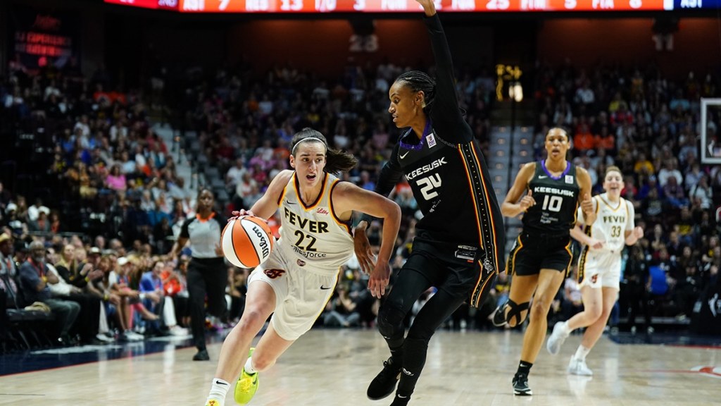 Indiana Fever guard Caitlin Clark (22) drives the ball against Connecticut Sun forward DeWanna Bonner (24) in the first quarter.