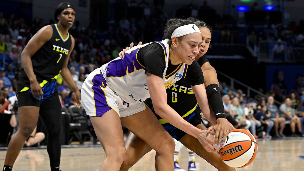 Los Angeles Sparks forward Dearica Hamby (5) and Dallas Wings forward Satou Sabally (0) battle for the loose ball during the second half at College Park Center.