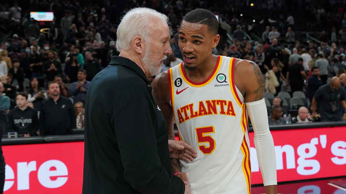 San Antonio Spurs head coach Gregg Popovich talks with Atlanta Hawks guard Dejounte Murray (5) after the game at the AT&T Center.