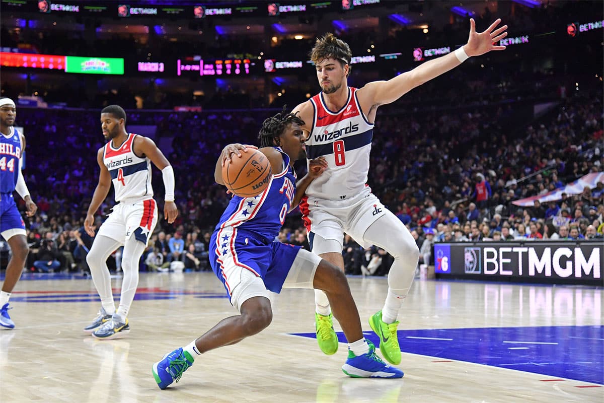 Philadelphia 76ers guard Tyrese Maxey (0) is defended by Washington Wizards forward Deni Avdija (8) during the second quarter at Wells Fargo Center