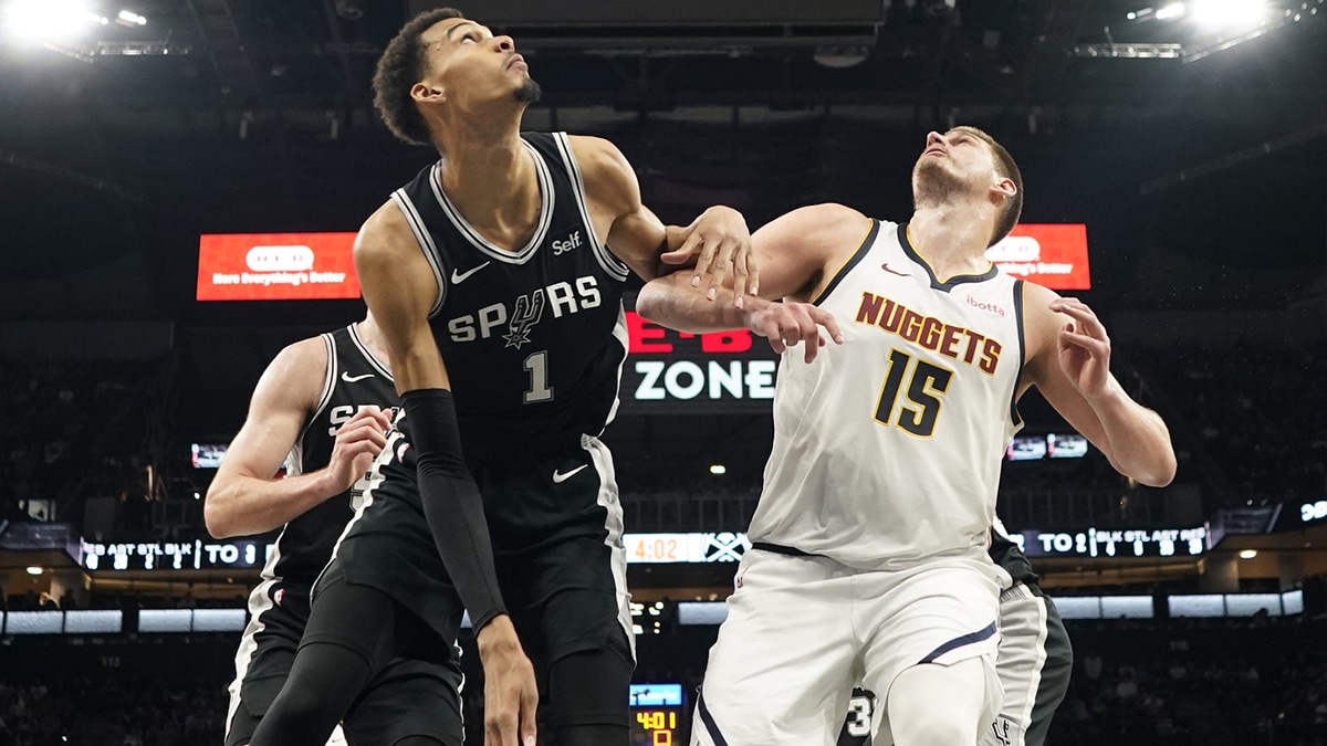 Denver Nuggets center Nikola Jokic (15) and San Antonio Spurs forward Victor Wembanyama (1) box out for a rebound during the second half at Frost Bank Center.