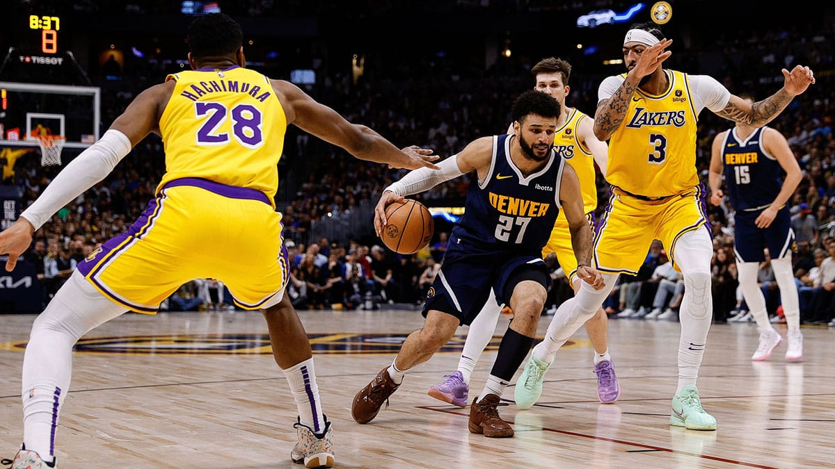 Apr 29, 2024; Denver, Colorado, USA; Denver Nuggets guard Jamal Murray (27) controls the ball against Los Angeles Lakers forward Rui Hachimura (28) and guard Austin Reaves (15) and forward Anthony Davis (3) in the third quarter during game five of the first round for the 2024 NBA playoffs at Ball Arena. Mandatory Credit: Isaiah J. Downing-USA TODAY Sports