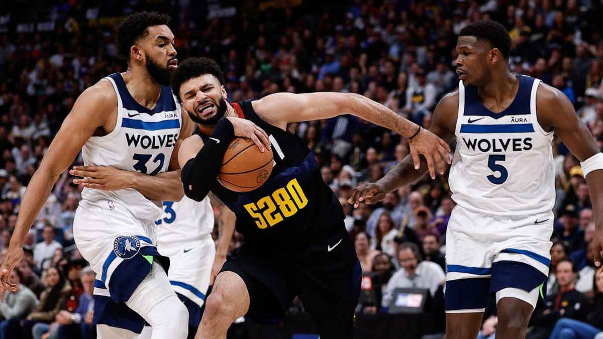 May 6, 2024; Denver, Colorado, USA; Denver Nuggets guard Jamal Murray (27) drives to the basket against Minnesota Timberwolves center Karl-Anthony Towns (32) and guard Anthony Edwards (5) in the third quarter during game two of the second round for the 2024 NBA playoffs at Ball Arena. Mandatory Credit: Isaiah J. Downing-USA TODAY Sports
